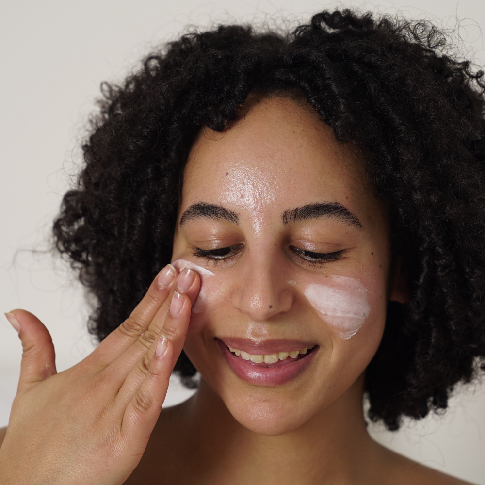 Femme utilisant la Baume visage régénérant à l'huile de baobab et à l'acide salicylique